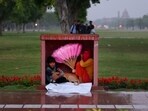 Heartwarming HT picture of a kid sheltering a dog from the rainfall in Delhi's Kartavya Path. Heartwarming HT picture of a kid sheltering a dog from the rainfall in Delhi's Kartavya Path.