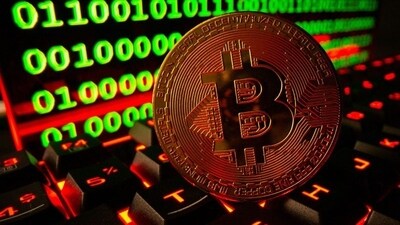 Bitcoin cryptocurrency representation is pictured on a keyboard in front of binary code. (REUTERS file photo)