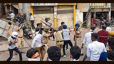 Police try to control mob after incidents of stone pelting on a Ram Navami procession, in Vadodara on Thursday. (PTI) Police try to control mob after incidents of stone pelting on a Ram Navami procession, in Vadodara on Thursday. (PTI)