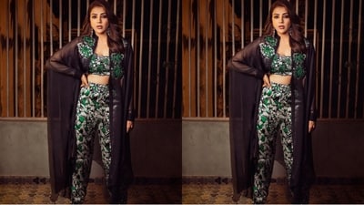 The three-piece outfit that Kajal Agarwal is wearing consists of a matching printed bralette and pants, along with a black netted full-length shrug.&nbsp; (Instagram/@kajalaggarwalofficial)