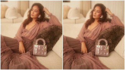 With a matching pastel pink clutch by her side, Mira posed on a couch and accessorised her look in black stilettos and statement silver ear cuffs.&nbsp; (Instagram/@mira.kapoor)