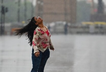 A woman enjoying Delhi rain. (HT Photo/Vipin Kumar) A woman enjoying Delhi rain. (HT Photo/Vipin Kumar)