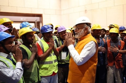 Prime Minister Narendra Modi interacts with the construction workers at the site of new Parliament complex.