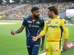 Gujarat Titans' Captain Hardik Pandya and Chennai Super Kings' Captain Mahendra Sinh Dhoni, right, walk to the field before the inauguration of the Indian Premier League (IPL) 2023 in Ahmedabad, India, Friday, March 31, 2023. (AP Photo/Ajit Solanki)