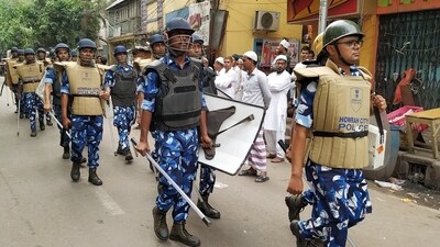 Rapid Action Force (RAF) personnel patrol the area to maintain law and order following the violence that broke out during the Ram Navami procession, in Howrah on Friday. (ANI Photo)