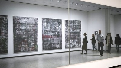 People reflected in a mirror oposite of the 'Birkenau' paintings in a new exhibition with art works of German artist Gerhard Richter at the New National Gallery in Berlin, Germany, Friday, March 31, 2023. Richter's foundation gave on permanent loan 100 works of the artist to the New National Gallery where they will be shown in the permanent exhibition. (AP Photo/Markus Schreiber) (AP) People reflected in a mirror oposite of the 'Birkenau' paintings in a new exhibition with art works of German artist Gerhard Richter at the New National Gallery in Berlin, Germany, Friday, March 31, 2023. Richter's foundation gave on permanent loan 100 works of the artist to the New National Gallery where they will be shown in the permanent exhibition. (AP Photo/Markus Schreiber) (AP)