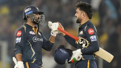 Gujarat Titans' Rahul Tewatia and Rashid Khan, right, celebrate after their team won the Indian Premier League (IPL) match against Chennai Super Kings in Ahmedabad, India, Friday, March 31, 2023. (AP Photo/Ajit Solanki) (AP)