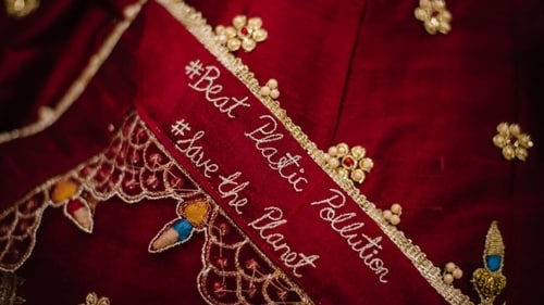 The couple got inspiring hashtags embroidered on their wedding outfits. (Greenmyna)