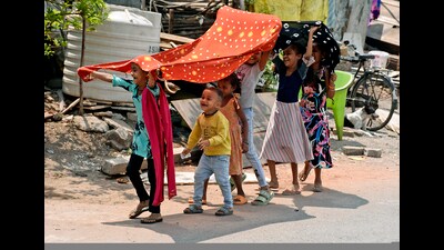 Children cover their heads with a piece of cloth to protect themselves from the scorching heat on a hot summer day, in Surat on March 27. (ANI) Children cover their heads with a piece of cloth to protect themselves from the scorching heat on a hot summer day, in Surat on March 27. (ANI)