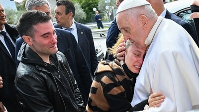 Pope Francis hugs a woman who came to him as he leaves the Gemelli hospital in Rome, after being discharged following treatment for bronchitis. (AFP)