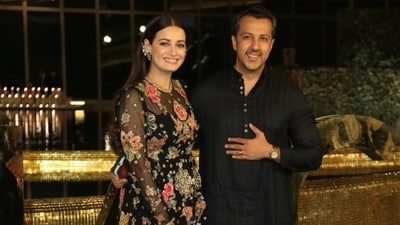 Dia Mirza and husband Vaibhav Rekhi were twinning in black at the nmacc event. Dia was in an embroidered gown and added a quirky ear accessory. (Varinder Chawla) Dia Mirza and husband Vaibhav Rekhi were twinning in black at the nmacc event. Dia was in an embroidered gown and added a quirky ear accessory. (Varinder Chawla)