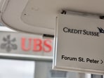 Logos of Swiss bank UBS and Credit Suisse.