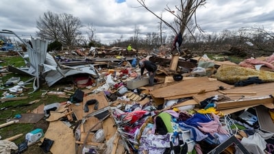 People walk through damage from a late-night tornado in Sullivan, Ind., US on April 1. (AP) People walk through damage from a late-night tornado in Sullivan, Ind., US on April 1. (AP)