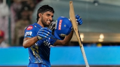Tilak Varma acknowledges the crowd as he walks back after the end of the Mumbai Indians inning during the IPL 2023 match against Royal Challengers Bangalore (PTI)