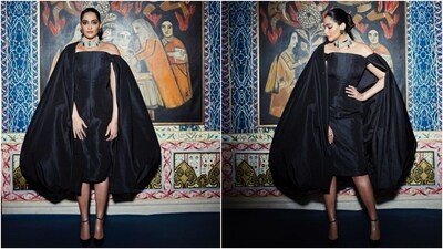 Sonam took to Instagram to share pictures of herself dressed in the stunning black-coloured ensemble with the caption, "Changed for the after party in custom @ashistudio and custom @amrapalijewels." The star wore a midi dress featuring statement sleeves that also acted as a cape. Her ethereal look got compliments from her followers online, including Anil Kapoor, Sunita Kapoor, and Nargis Fakhri. (Instagram) Sonam took to Instagram to share pictures of herself dressed in the stunning black-coloured ensemble with the caption, "Changed for the after party in custom @ashistudio and custom @amrapalijewels." The star wore a midi dress featuring statement sleeves that also acted as a cape. Her ethereal look got compliments from her followers online, including Anil Kapoor, Sunita Kapoor, and Nargis Fakhri. (Instagram)