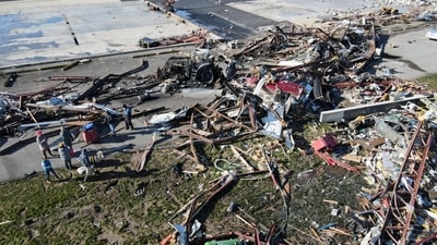 People search for salvageable parts near destroyed aircraft, hangar pieces, and other debris as they lay at Robinson Municipal Airport, two days after a tornado hit Palestine, Illinois, U.S., April 2, 2023.  REUTERS/Jon Cherry (REUTERS)