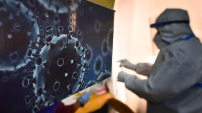 An illustration of the novel coronavirus seen next to a health care worker at a Covid-19 testing centre. (Sanchit Khanna / HT Photo) An illustration of the novel coronavirus seen next to a health care worker at a Covid-19 testing centre. (Sanchit Khanna / HT Photo)