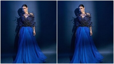 Mouni looked like a dream in a blue gown designed with dramatic blue and black embellishments on the torso, adding to the mystic look of the gown. The attire further cascaded to blue silk skirt in long and flowy pattern. (Instagram/@imouniroy) Mouni looked like a dream in a blue gown designed with dramatic blue and black embellishments on the torso, adding to the mystic look of the gown. The attire further cascaded to blue silk skirt in long and flowy pattern. (Instagram/@imouniroy)