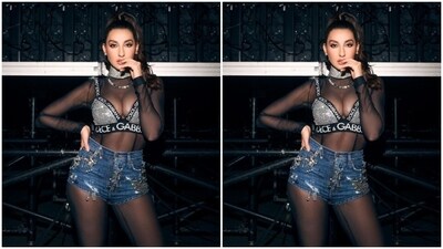 Here's a picture of Nora in a silver sequined bra, a black netted translucent top and a pair of denim shorts with silver embellishments. (Instagram/@norafatehi) Here's a picture of Nora in a silver sequined bra, a black netted translucent top and a pair of denim shorts with silver embellishments. (Instagram/@norafatehi)