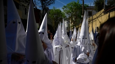 Penitents of La Paz brotherhood gather at the church prior to participating in the Palm Sunday procession, in Spain. (AFP) Penitents of La Paz brotherhood gather at the church prior to participating in the Palm Sunday procession, in Spain. (AFP)