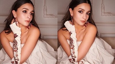 Alia Bhatt amped up her glamorous look with statement ethnic earrings, smoky eyes, and nude lips. She left her curls open in middle parting, completing the effortlessly chic finish to her stunning outfit. (Instagram/@rheakapoor)