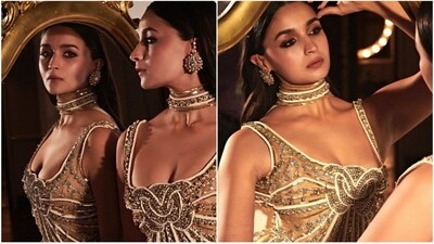 Alia Bhatt paired her golden gown with heavy statement earrings and a minimal makeup look, finishing off the elegant ensemble with a sleek, straight middle-parted hairstyle. (Instagram/@Aliabhatt)