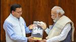 Prime Minister Narendra Modi with Uttarakhand chief minister Pushkar Singh Dhami during a meeting, in New Delhi, Monday (PTI)