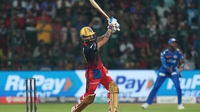 Virat Kohli goes down the ground against MI (PTI) Virat Kohli goes down the ground against MI (PTI)