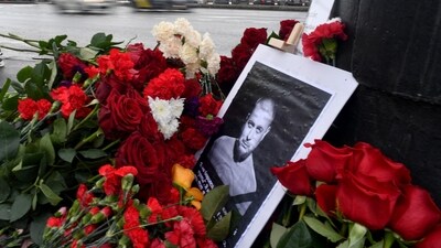 A portrait of Russian military blogger Vladlen Tatarsky, whose real name is Maxim Fomin, who was killed in the April 2 bomb blast in a cafe, is seen among flowers at a makeshift memorial by the explosion site in Saint Petersburg on Monday. (AFP) A portrait of Russian military blogger Vladlen Tatarsky, whose real name is Maxim Fomin, who was killed in the April 2 bomb blast in a cafe, is seen among flowers at a makeshift memorial by the explosion site in Saint Petersburg on Monday. (AFP)