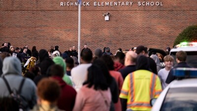 Students and police gather outside of Richneck Elementary School after a shooting. (AP) Students and police gather outside of Richneck Elementary School after a shooting. (AP)