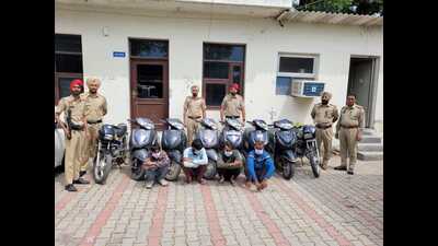 The accused and the recovered two-wheelers in the custody of Mohali police. (HT Photo)