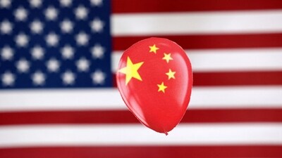 China Spy Balloon: A printed balloon with Chinese flag is placed on a US flag in this illustration. (Reuters)