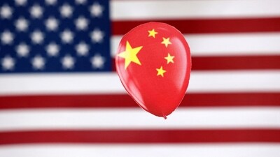 China Spy Balloon: A printed balloon with Chinese flag is placed on a US flag in this illustration. (Reuters)