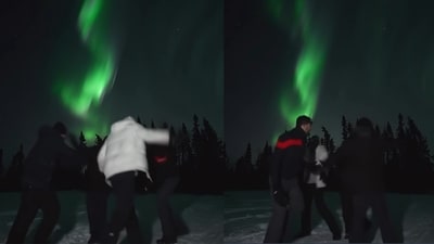 The image, taken from the Instagram video, shows a group of men dancing under the Northern Lights in Alaska. (Instagram/@the_binary_traveller)