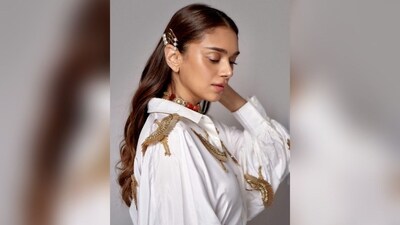 Aditi Rao Hydari opted for a minimalistic makeup look with a glowy base, nude lipstick, and shimmer eye shadow. She kept her luscious curls open in a middle partition and added pearl bobby pins to add elegance to her hairdo. (Instagram/@aditiraohydari)