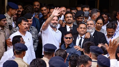Congress leader Rahul Gandhi waves at supporters as he leaves from Surat District Court after filing an appeal challenging his conviction and sentencing in the 2019 criminal defamation case over the 'Modi surname' remark, in Surat, Monday, April 3, 2023. (PTI)