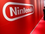 A man stands in front of Nintendo's logo.