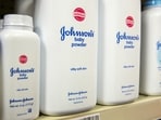 Bottles of Johnson & Johnson baby powder line a drugstore shelf in New York.