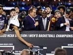  Alex Karaban #11 of the Connecticut Huskies places the UConn name in the national champion spot after defeating the San Diego State Aztecs 76-59 during the NCAA Men's Basketball Tournament National Championship game at NRG Stadium on April 03, 2023 in Houston, Texas.  