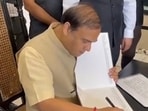 Assam CM Himanta Biswa Sarma reportedly writing his comments in a visitor's book. Assam CM Himanta Biswa Sarma reportedly writing his comments in a visitor's book.