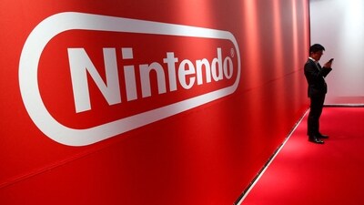 A man stands in front of Nintendo's logo. (REUTERS)