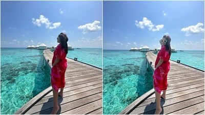 Neha soaks up some Vitamin D in these pictures dressed in a red and pink midi dress featuring a floral design. She styled it with open hair, a sleek watch, and sunglasses. (Instagram) Neha soaks up some Vitamin D in these pictures dressed in a red and pink midi dress featuring a floral design. She styled it with open hair, a sleek watch, and sunglasses. (Instagram)