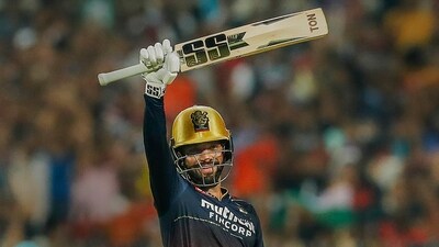 Rajat Patidar of Royal Challengers Bangalore raises his bat after scoring a century (PTI)