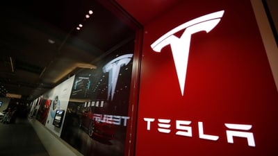 A sign bearing the Tesla company logo is displayed outside a Tesla store. (AP) A sign bearing the Tesla company logo is displayed outside a Tesla store. (AP)