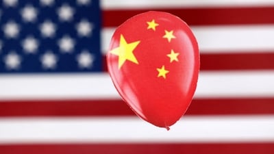 China Spy Balloon: A printed balloon with Chinese flag is placed on a US flag in this illustration. (Reuters)