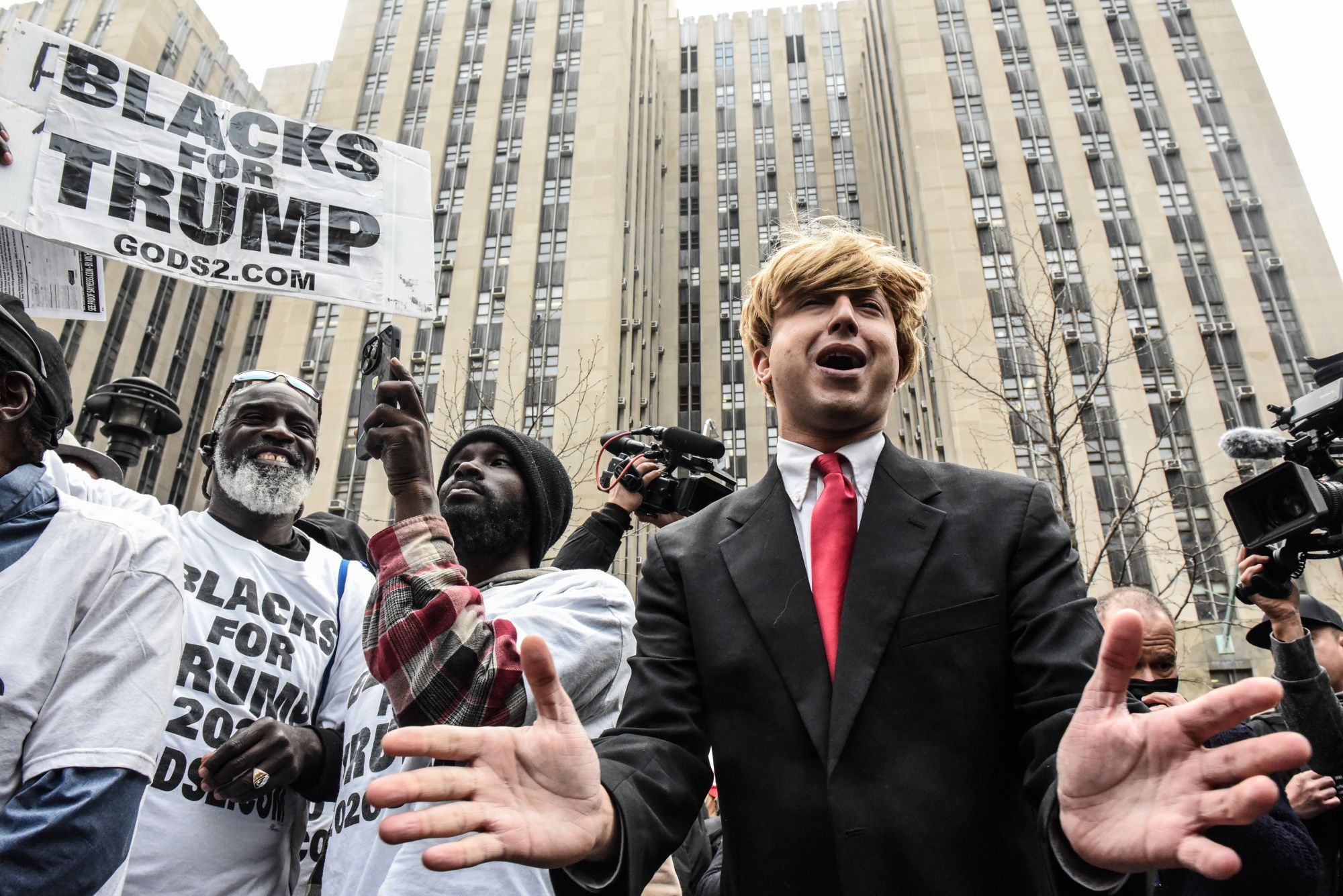 A protestor, center, next to supporters of former US President Donald Trump outside criminal court in New York, US, on Tuesday, April 4, 2023. (Bloomberg) A protestor, center, next to supporters of former US President Donald Trump outside criminal court in New York, US, on Tuesday, April 4, 2023. (Bloomberg)