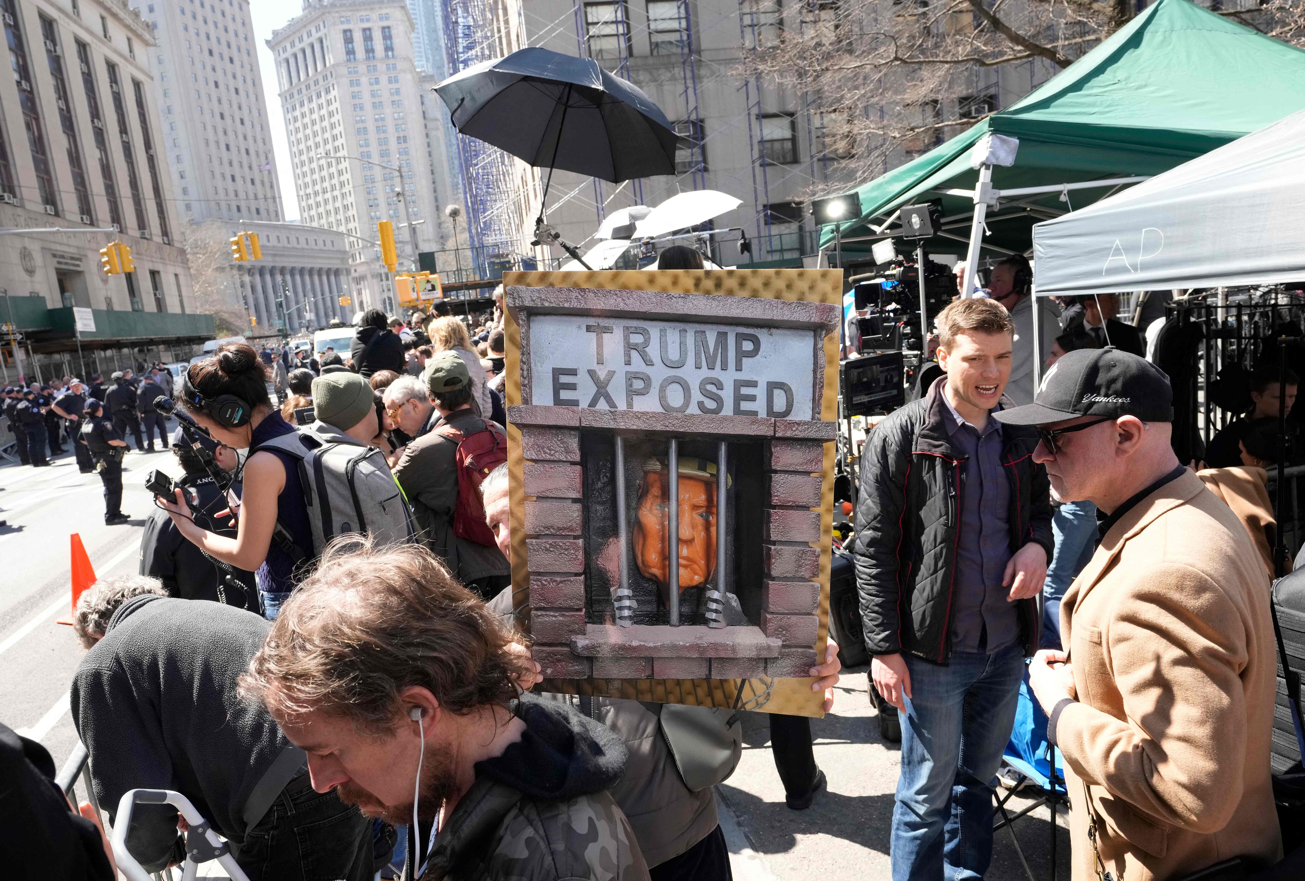 A protester holds a sign while gathering outside the Manhattan Criminal Courthouse. (AFP) A protester holds a sign while gathering outside the Manhattan Criminal Courthouse. (AFP)