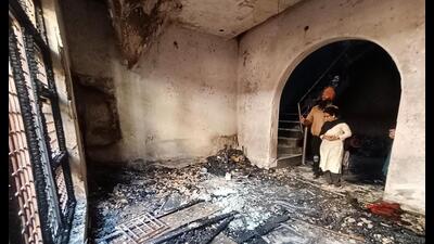 Neighbours at the fire-ravaged house where three members of a family died at Rose Enclave Islamadad in Amritsar on Wednesday. (Sameer Sehgal/HT) Neighbours at the fire-ravaged house where three members of a family died at Rose Enclave Islamadad in Amritsar on Wednesday. (Sameer Sehgal/HT)