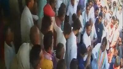 The Congress MLA (bottom right) seen slapping the cooperative bank employee. (CCTV footage/Twitter) The Congress MLA (bottom right) seen slapping the cooperative bank employee. (CCTV footage/Twitter)