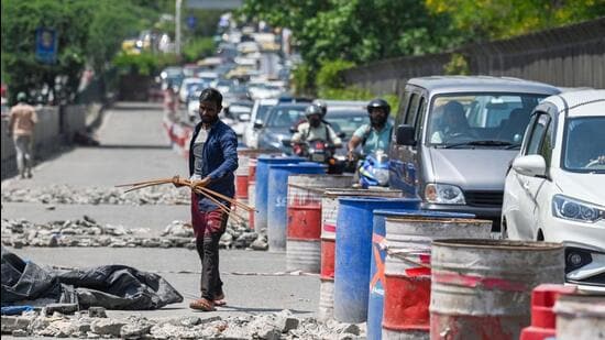 Workers repair Chirag Delhi flyover. (Raj K Raj/HT Photo)